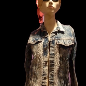 May include: A blue denim jacket with white lace trim. The jacket has a button-up front and a classic style.