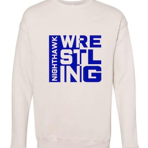 May include: Cream-colored sweatshirt with the words "WRESTLING STL" in blue block letters. The word "NIGHTHAWK" is printed vertically in blue on the left side of the design. The sweatshirt has a crew neck and long sleeves.