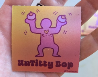 Pegatina "UnTitty Bop", vinilo, cirugía de pecho, afirmación de género, recaudación de fondos, transgénero, orgullo trans, Keith Haring, arte pop