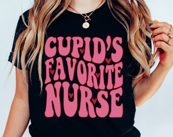 May include: Black t-shirt with the text "Cupid's Favorite Nurse" in pink, with small red heart accents. The design has a retro, groovy font. The shirt is a crew neck style.