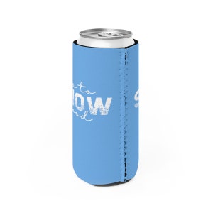 May include: A light blue can cooler with the text "Let it snow" in white. The cooler has a zippered seam on the side.