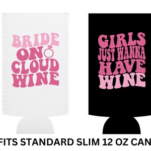 May include: Two white and black can coolers with pink text. The white cooler says "Bride on Cloud Wine" with a diamond ring symbol. The black cooler says "Girls Just Wanna Have Wine". Both coolers fit standard slim 12 oz cans.