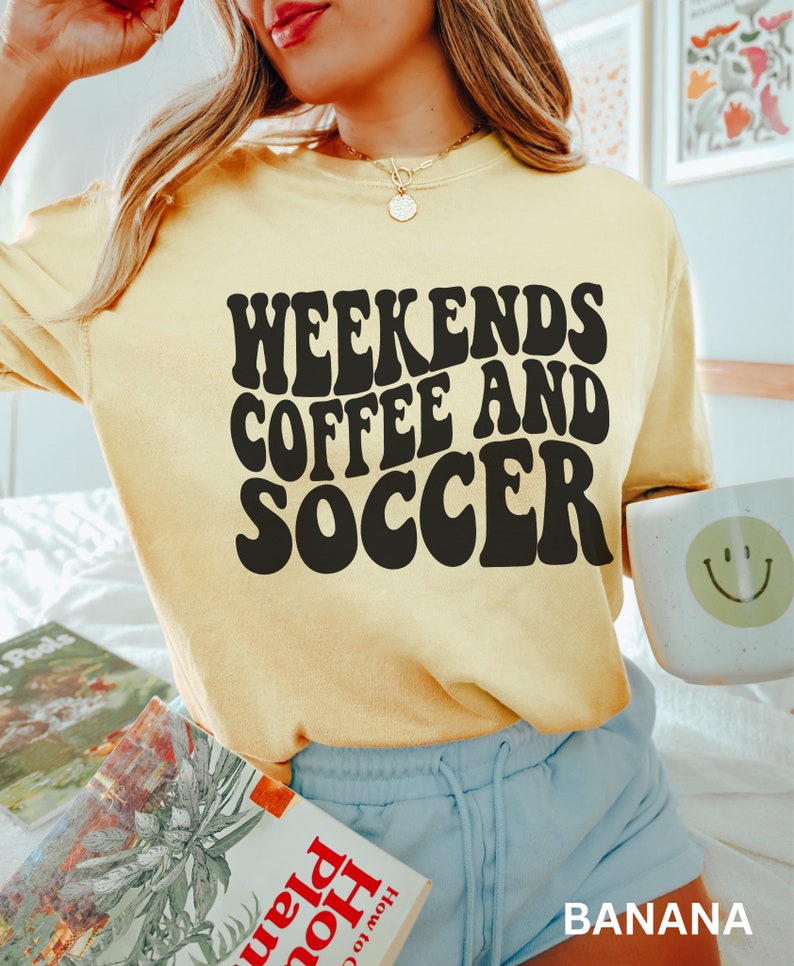 May include: A yellow t-shirt with the text "Weekends Coffee and Soccer" in black retro font.