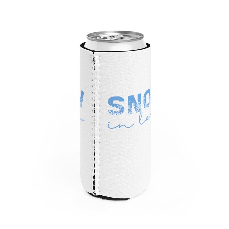 May include: White can cooler with a blue design that says "SNOW in LA".