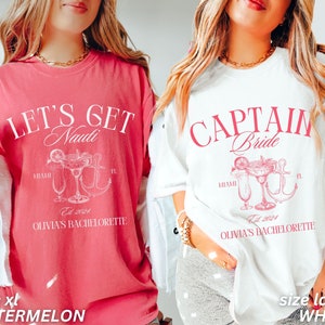 May include: Two oversized t-shirts, one in watermelon and one in white, with pink text. The watermelon shirt reads "LET'S GET Naudi" with a cocktail and anchor graphic. The white shirt says "CAPTAIN Bride" with a cocktail and anchor graphic. Both say "OLIVIA'S BACHELORETTE" and "Est 2024".