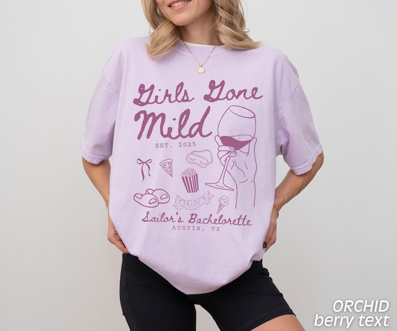 May include: Purple t-shirt with the text "Girls Gone Mild Est. 2025" and a graphic of a wine glass, a pizza slice, popcorn, a cupcake, and flip flops. The text "Sailor's Bachelorette Austin, TX" is below the graphic.