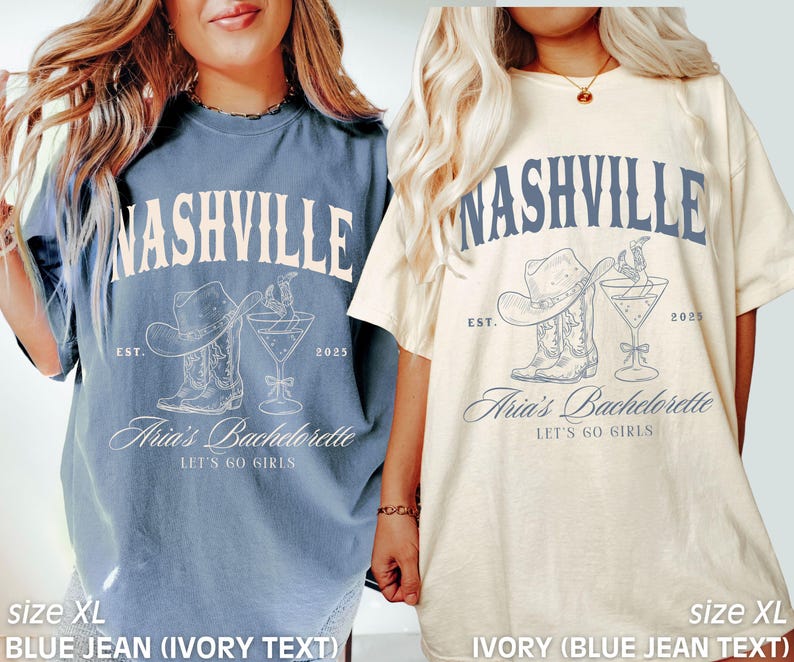 May include: Two oversized t-shirts, one blue and one ivory, each featuring a Nashville-themed design. The design includes the word "Nashville," a cowboy hat, boots, and a cocktail glass. The text "Aria's Bachelorette" and "Let's Go Girls" are also present.
