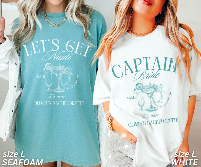 May include: Two oversized t-shirts, one seafoam and one white, with matching graphic designs. The seafoam shirt reads "LET'S GET Nauti" with a cocktail and anchor illustration. The white shirt says "CAPTAIN Bride" with a similar design. Both shirts say "Miami, FL" and "Olivia's Bachelorette".