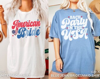 May include: Two oversized t-shirts with red, white, and blue text and stars. The white shirt says "American Bride" with a heart containing the American flag. The blue shirt says "Bach Party in the USA".