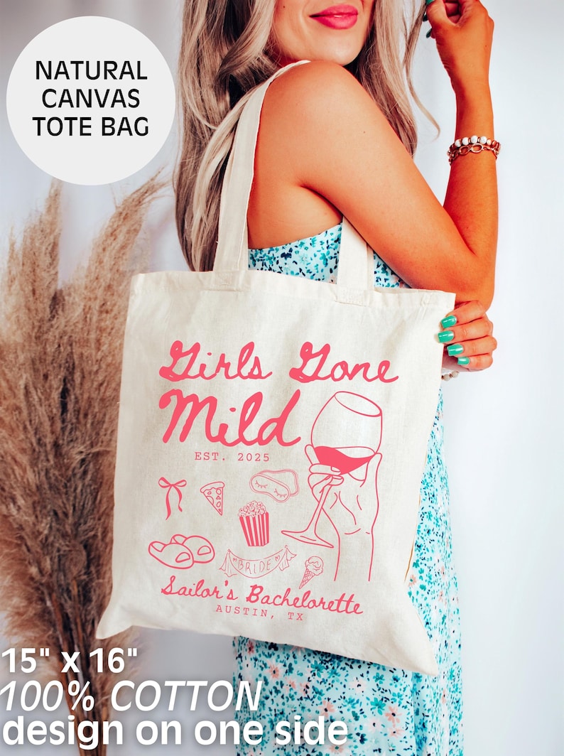 May include: A natural canvas tote bag with the text "Girls Gone Mild EST. 2025" in pink lettering. The bag also features a pink illustration of a hand holding a glass of wine, along with other pink illustrations of a pizza slice, popcorn, a pair of flip flops, and an ice cream cone. The text "Sailor's Bachelorette Austin, TX" is also printed in pink lettering.