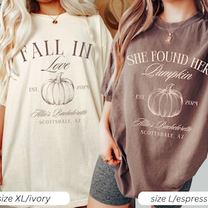 May include: Two t-shirts with fall-themed designs. The ivory t-shirt says "Fall in Love" with a pumpkin and the text "Allie's Bachelorette Scottsdale, AZ" and "EST. 2024". The brown t-shirt says "She Found Her Pumpkin" with a pumpkin and the text "Allie's Bachelorette Scottsdale, AZ" and "EST. 2024".