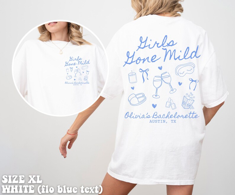 May include: White t-shirt with blue text that says "Girls Gone Mild" and includes illustrations of wine glasses, a sleep mask, and other party favours. The text "Olivia's Bachelorette Austin, TX" is also included.