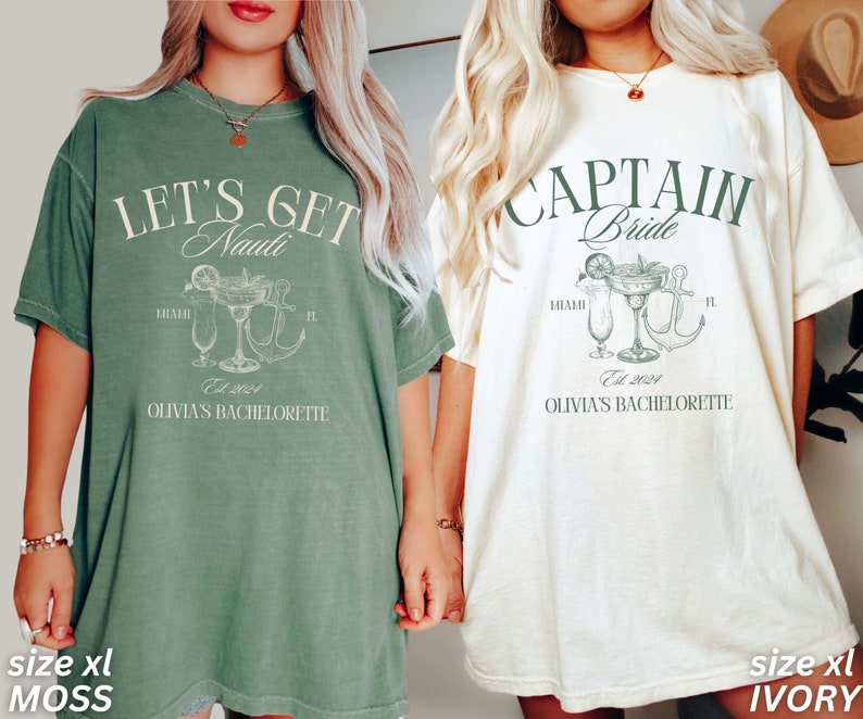 May include: Two oversized t-shirts, one moss green and one ivory, with nautical designs. The green shirt reads "Let's Get Nauti", the ivory shirt says "Captain Bride". Both have cocktail and anchor illustrations, with "Olivia's Bachelorette" and "Est. 2024".