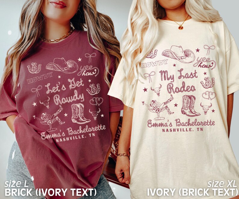 May include: Two t-shirts with a bachelorette party theme. The left shirt is brick red with ivory text that says "Howdy, Yee Haw, Let's Get Rowdy, Emma's Bachelorette, Nashville, TN". The right shirt is ivory with brick red text that says "Howdy, Yee Haw, My Last Rodeo, Emma's Bachelorette, Nashville, TN".