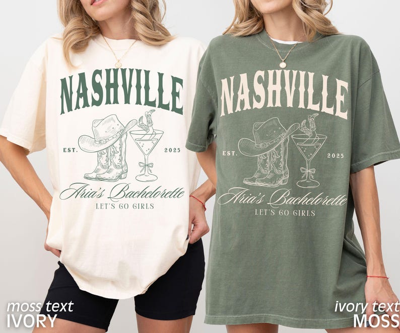 May include: Two t-shirts, one ivory and one moss green, feature a Nashville-themed graphic. The design includes the word "NASHVILLE", a cowboy hat, boots, a cocktail, and the text "Aria's Bachelorette, Let's Go Girls".