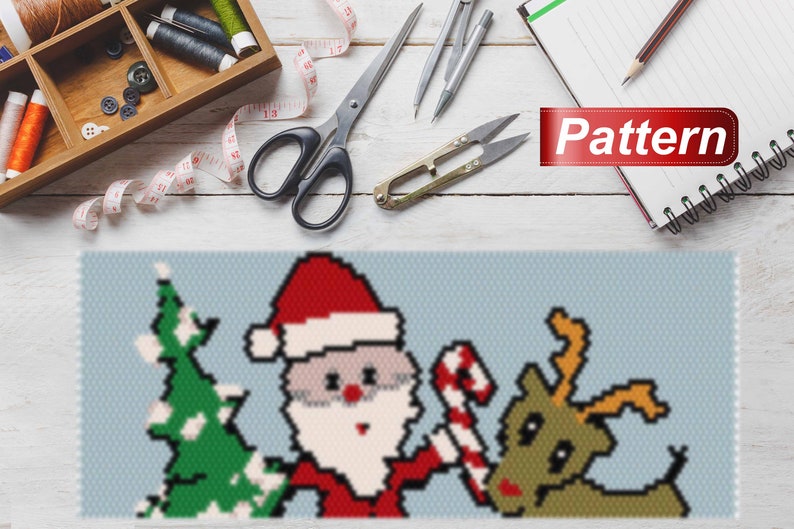 May include: A pixel art pattern of Santa Claus, a Christmas tree, and a reindeer. The pattern is on a blue background and includes the word "Pattern".
