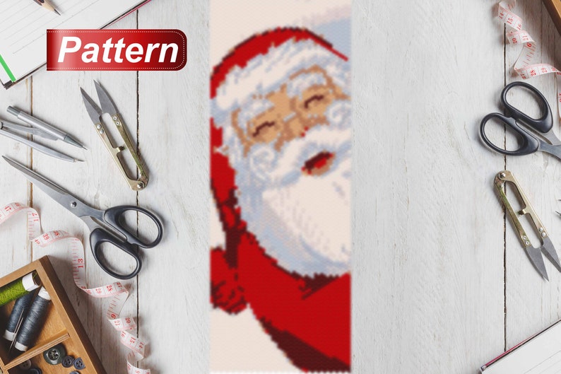 May include: A close-up of a Santa Claus bead pattern for a Christmas craft project. The pattern features a red and white Santa Claus with a white beard and a red hat.