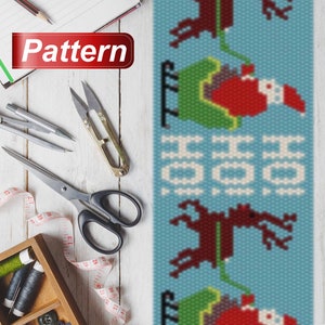 May include: A beaded pattern for a Christmas ornament featuring a repeating design of Santa Claus riding in a sleigh pulled by reindeer. The pattern is on a blue background with white snowflakes.