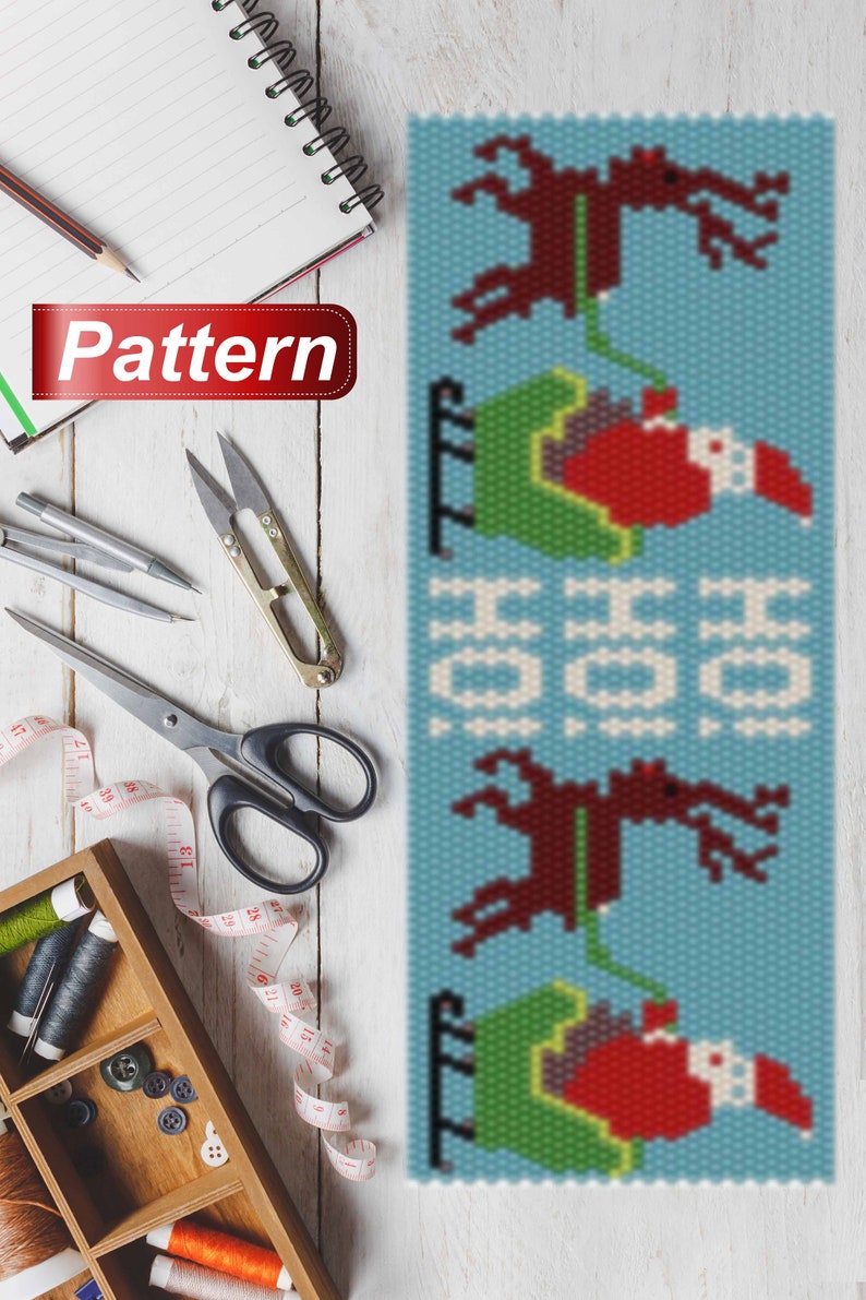 May include: A beaded pattern for a Christmas ornament featuring a repeating design of Santa Claus riding in a sleigh pulled by reindeer. The pattern is on a blue background with white snowflakes.