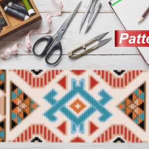May include: A vibrant geometric pattern featuring red, orange, blue, and black shapes. The word "Pattern" is displayed on a red banner. Sewing tools, including scissors, thread, and a tape measure, are arranged on a white wooden surface.