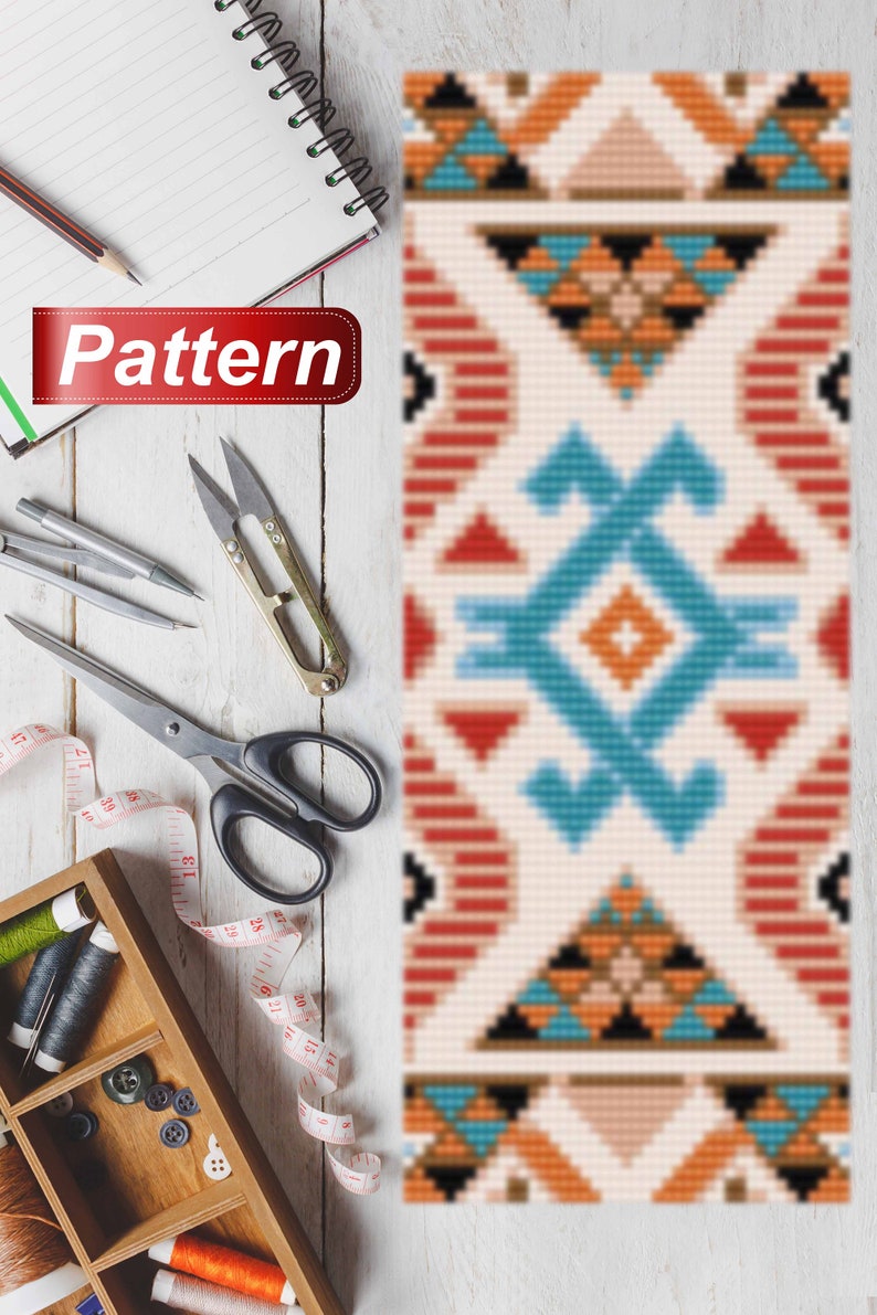 May include: A vibrant geometric pattern in beige, blue, orange, and red. The word "Pattern" is on a red banner. Sewing tools, including scissors, thread, and a measuring tape, are arranged on a white wooden surface.