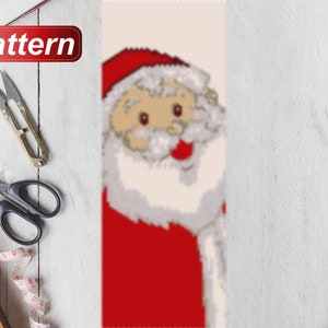 May include: A beaded pattern for a Christmas ornament featuring a Santa Claus with a red hat, white beard, and a red suit.