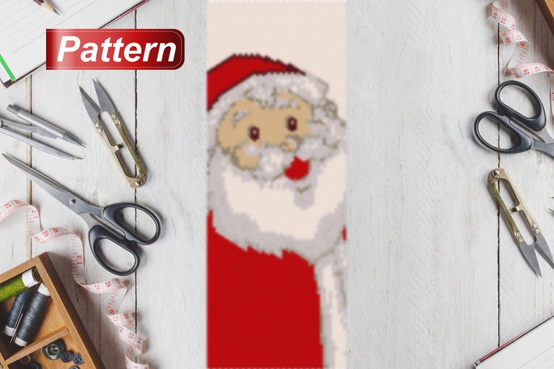 May include: A beaded pattern for a Christmas ornament featuring a Santa Claus with a red hat, white beard, and a red suit.