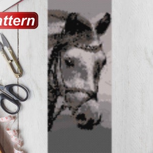 May include: A close-up of a beaded horse head pattern. The horse is gray with a black bridle and black mane. The beads are arranged in a pixelated style.