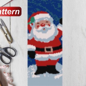 May include: A pixelated image of Santa Claus in a red suit with a white beard and black boots. He is standing in the snow with a blue background. The image is labeled "Pattern".