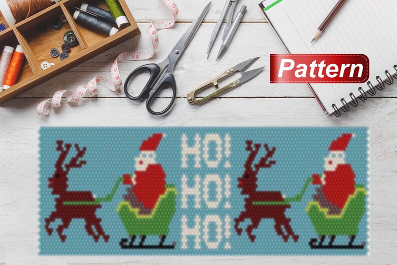 May include: A beaded pattern for a Christmas ornament featuring Santa Claus riding in a sleigh pulled by reindeer. The pattern includes the words "HO! HO! HO!" in white beads on a blue background.