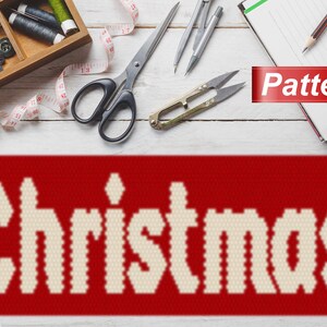 May include: A red and white Christmas pattern with the word "Christmas" in white letters on a red background. The pattern is surrounded by sewing supplies, including scissors, thread, and a measuring tape.