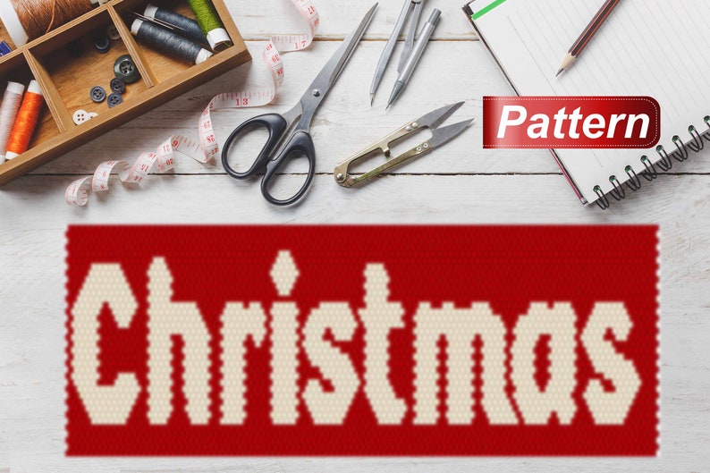 May include: A red and white Christmas pattern with the word "Christmas" in white letters on a red background. The pattern is surrounded by sewing supplies, including scissors, thread, and a measuring tape.