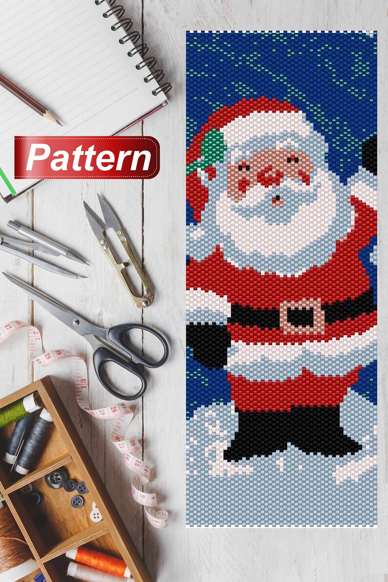 May include: A beaded pattern of Santa Claus in a red suit with a white beard and a black belt. He is standing in the snow with a blue background.