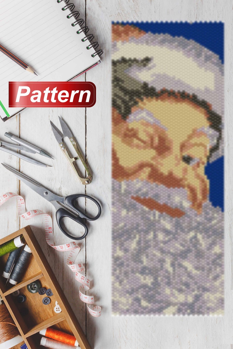 May include: A beaded pattern of Santa Claus's face with a white beard and a blue background. The pattern is made with small beads and is suitable for a craft project.