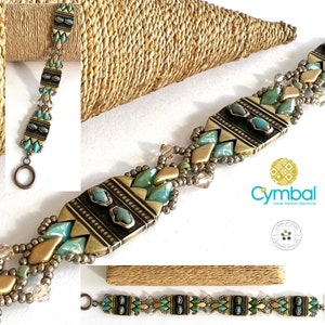 May include: A turquoise and gold beaded bracelet with a large, rectangular, brass-colored pendant. The pendant has a geometric design with black accents. The bracelet is made with metal fashion elements and is handmade jewelry.