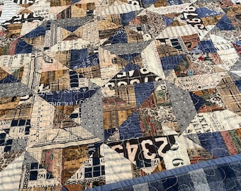 Large quilted throw in blues, browns, and whites.