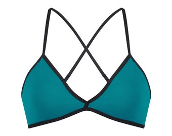 May include: Teal triangle bikini top with black trim and criss-cross straps.