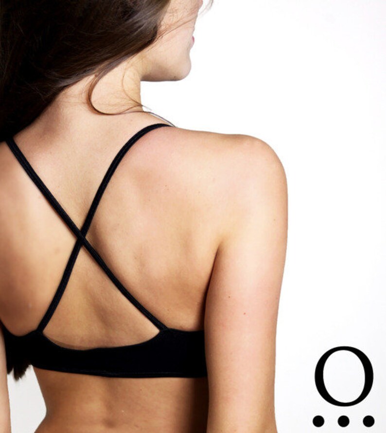 May include: A black sports bra with a criss-cross back and adjustable straps.