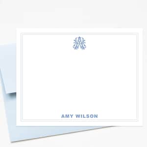 May include: A white stationery set with a light blue border and a matching envelope. The stationery features a monogram in the upper right corner and the name "AMY WILSON" in light blue at the bottom.