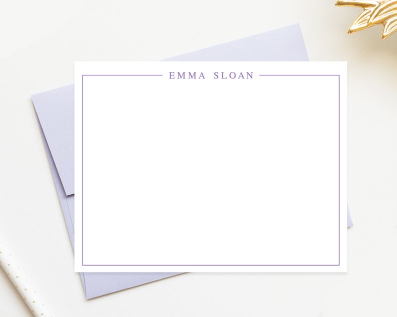 May include: A white card with a purple border and the text "EMMA SLOAN" printed in the center.