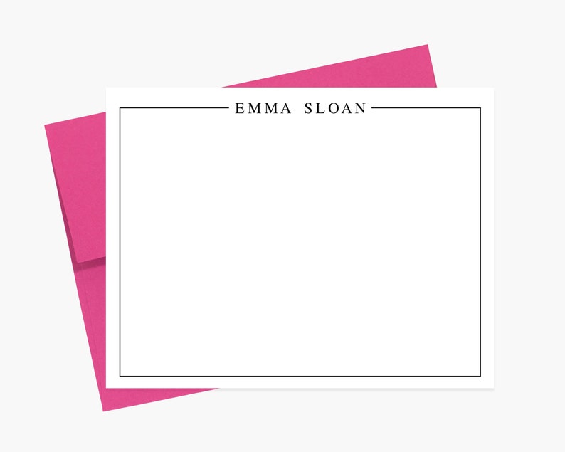 May include: A white stationery card with a black border and the text "EMMA SLOAN" printed in black at the top. The card is folded in half and has a pink envelope.