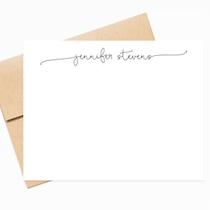 May include: A white card with a handwritten name, "jennifer stevens", at the top. The card is folded in half and is sitting on top of a brown envelope.