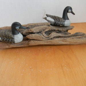 Vintage Ducks Sitting on a piece of Driftwood