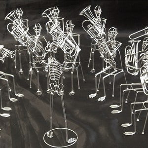 May include: A skeletal band plays musical instruments, including a trombone, trumpet, tuba, and a variety of other instruments. The band members are made of wire and are posed in a realistic playing position.