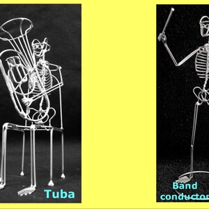 May include: Two wire sculptures of skeletons, one playing a tuba and the other conducting. The sculptures are made of thin wire and are posed in a realistic manner. The tuba player is sitting on a chair and the conductor is standing with a baton raised in the air. The sculptures are both black and white.