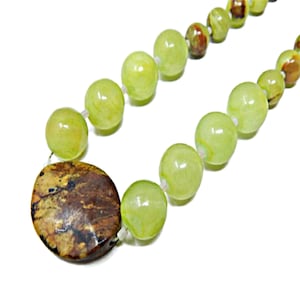 May include: A white ceramic mug with a black handle and the text "But First, Coffee" in a handwritten style. The mug is on a white surface. The mug is 4 inches tall.