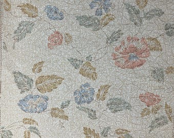 May include: Beige wallpaper with a floral pattern. The flowers are pink, blue, and brown. The leaves are green and brown.