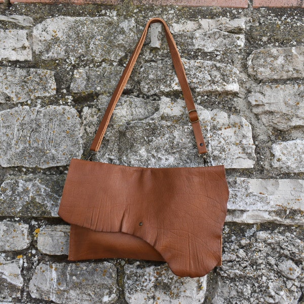 Brown cognac leather clutch with irregular flap