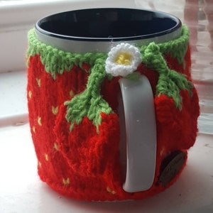 Knitted strawberry mug cosy