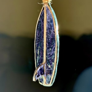 May include: A trio of ceramic mugs with a speckled, matte finish in cream, light grey, and dark grey. Each mug features a simple, minimalist design, ideal for tea or coffee.